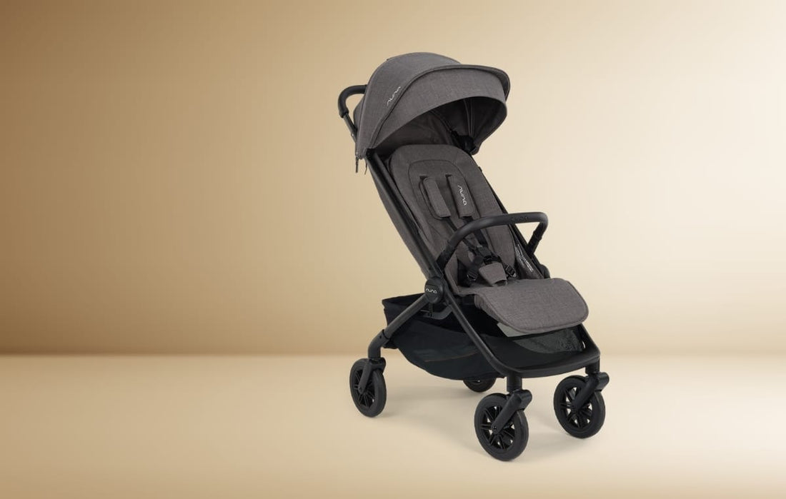 nuna TRVL 360 in color Pewter against a gold background.
