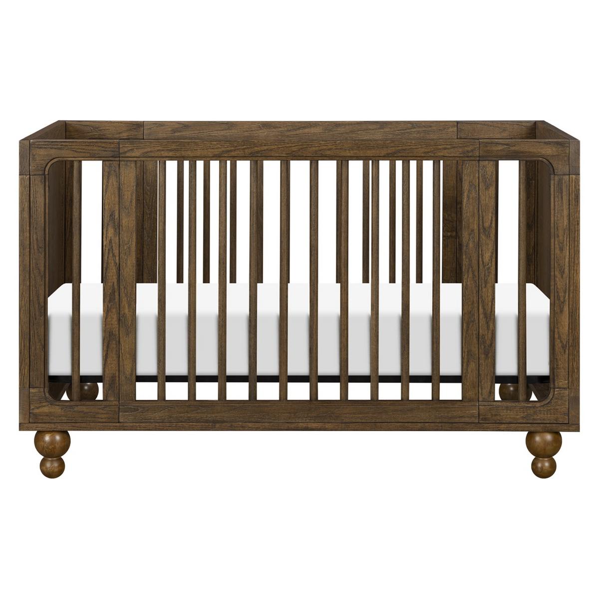 Babyletto wooden crib with vertical slats and round feet