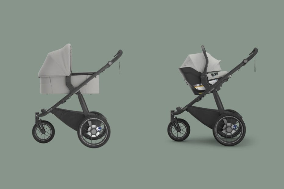 Two modern strollers with black frames and light gray bassinet and car seat attachments, side-by-side on a muted green background.