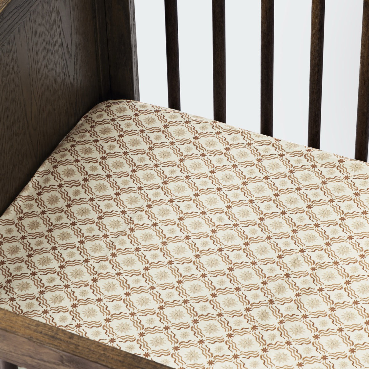Babyletto crib sheet with brown and cream geometric star pattern