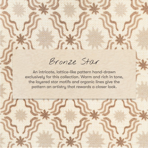 Babyletto Bronze Star fabric pattern with brown stars and wavy lines on cream background