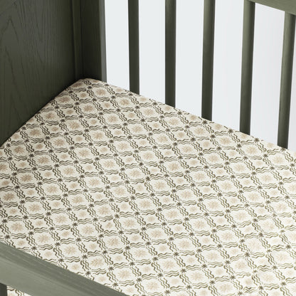 Babyletto crib sheet with a beige and olive green star and wave grid pattern