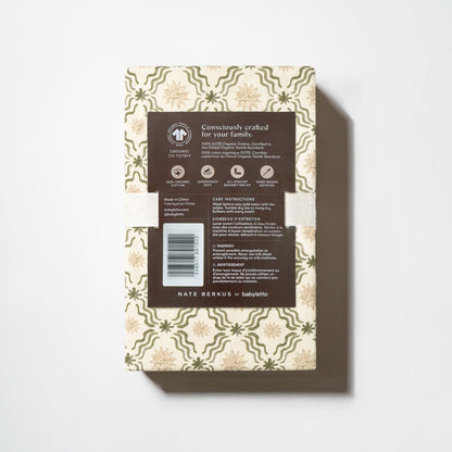 Babyletto Nate Berkus bassinet sheet packaging with product details and GOTS organic cotton certification