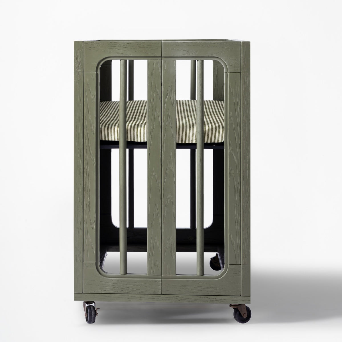 Babyletto olive green wooden bassinet with striped mattress on wheels