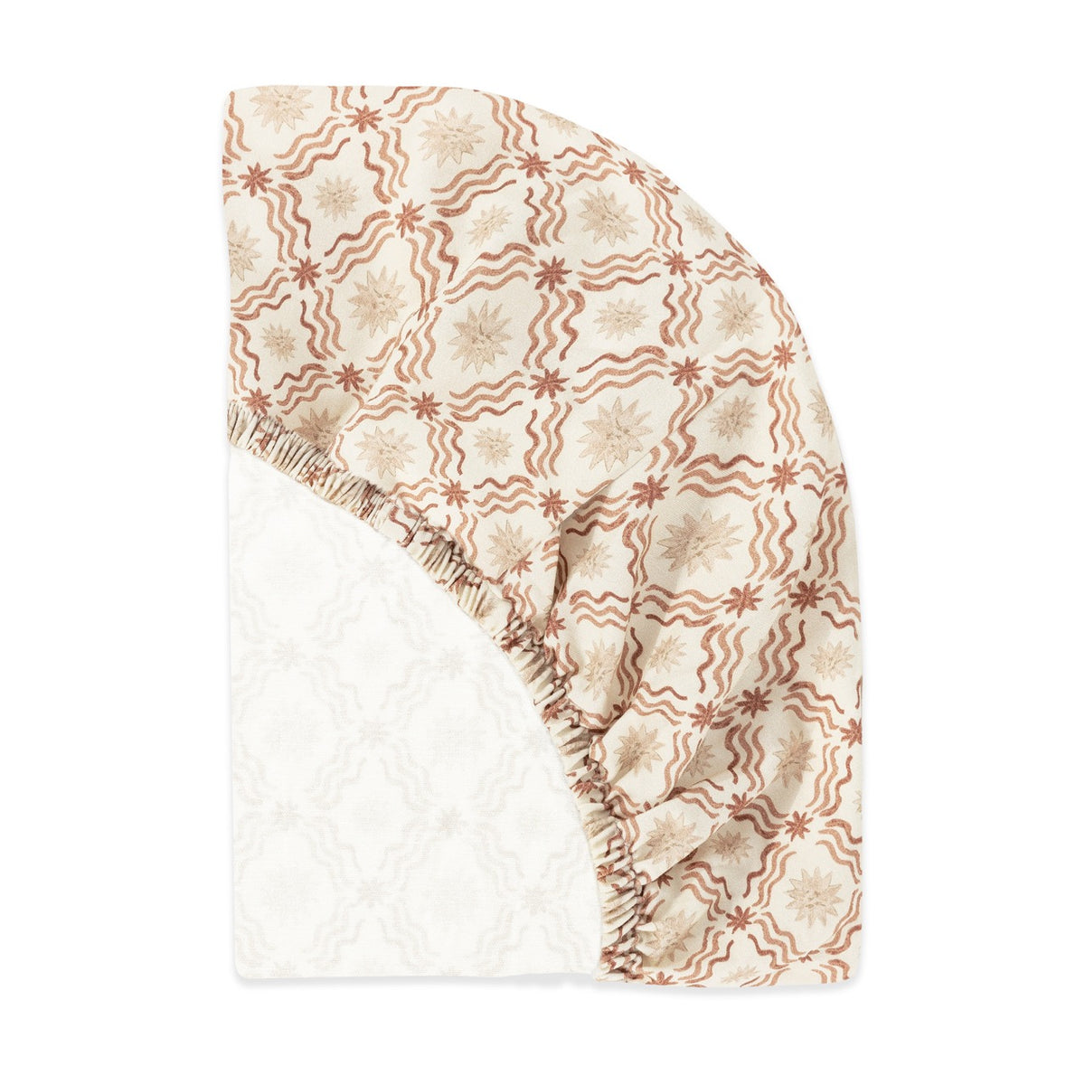 Babyletto fitted crib sheet with tan star and wavy line pattern on cream background