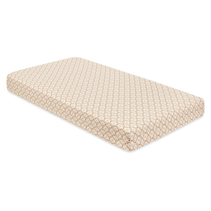 Babyletto crib mattress with a beige and white geometric pattern