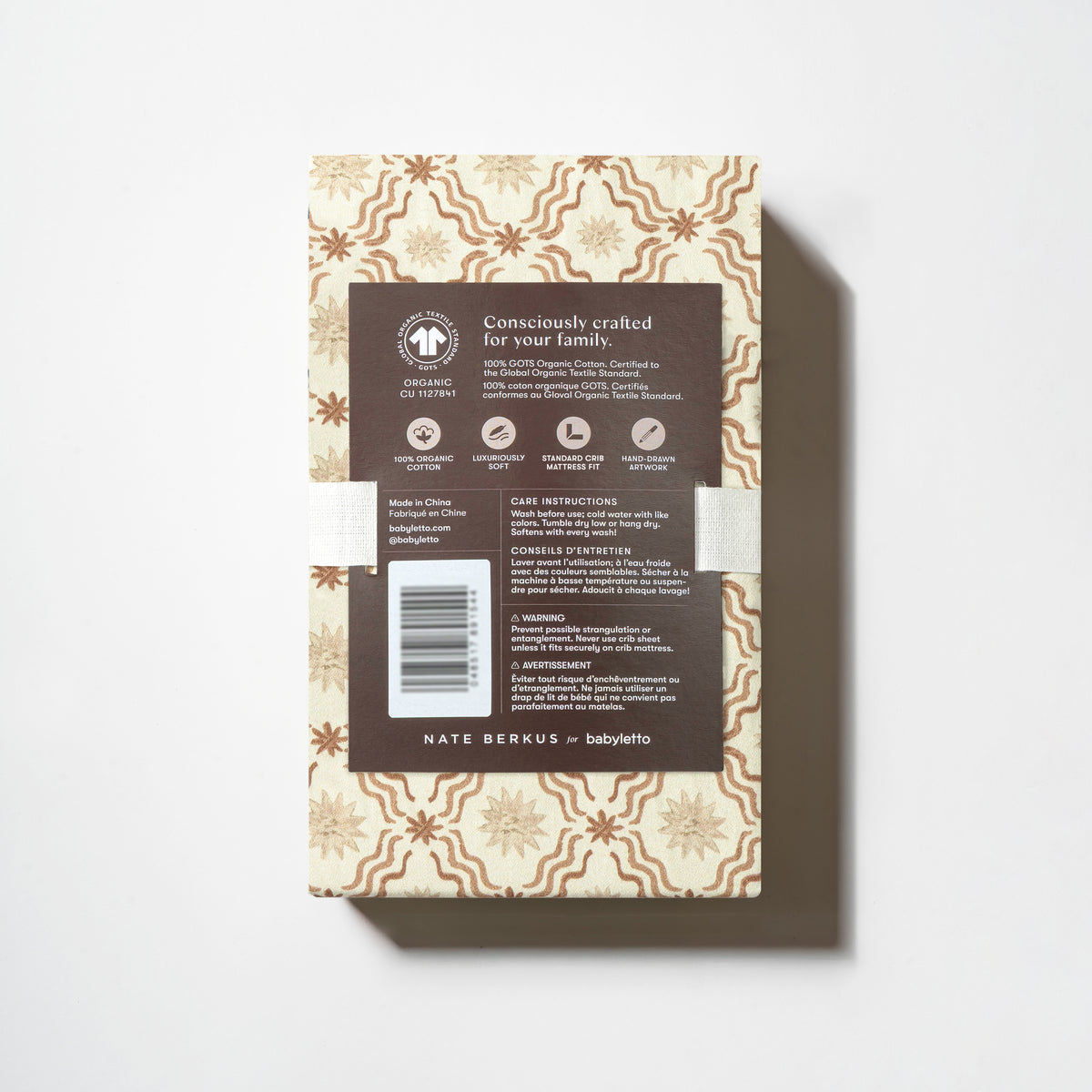 Babyletto Nate Berkus crib sheet packaging with product information and GOTS organic cotton certification