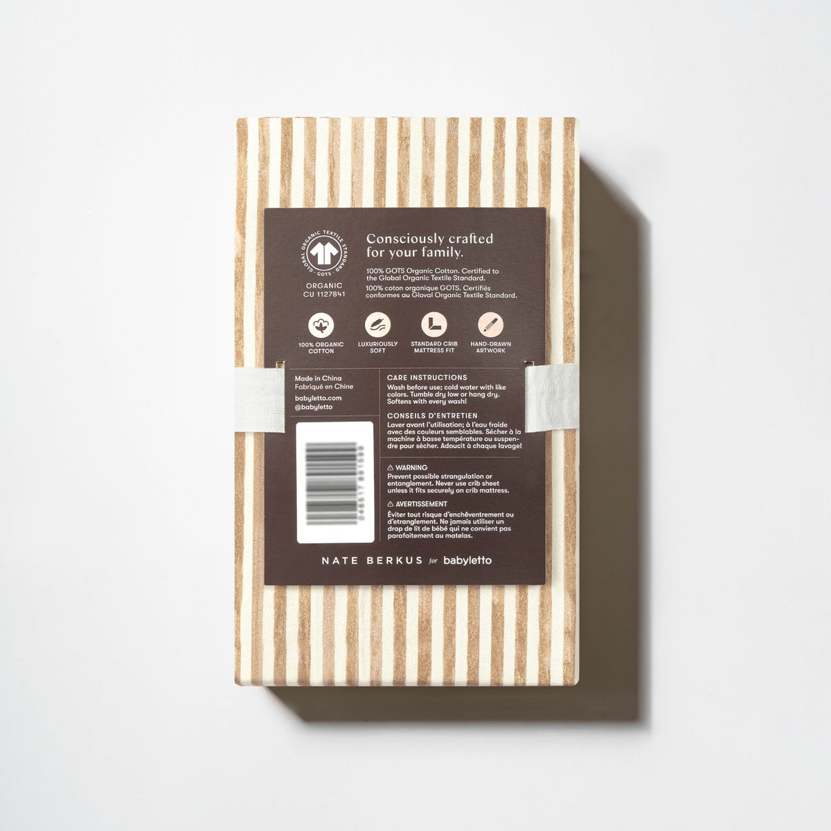 Babyletto crib sheet packaging with product information and care instructions