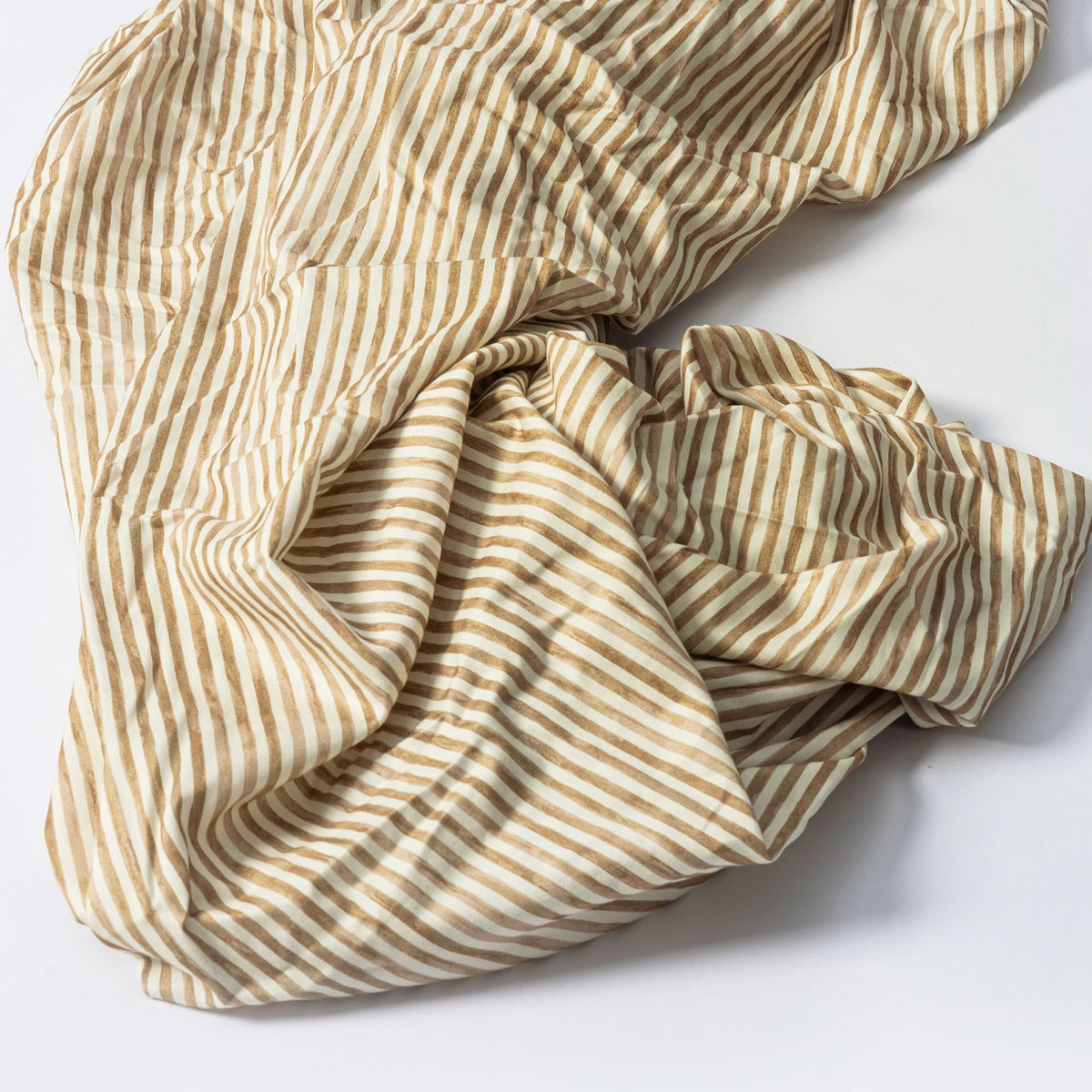 Babyletto crib sheet with tan and white vertical stripes