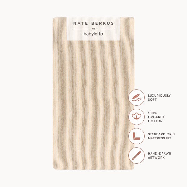 Babyletto Nate Berkus organic cotton crib sheet with vertical line pattern and product feature icons
