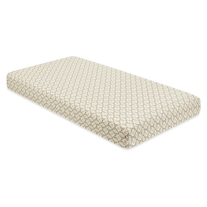 Babyletto crib mattress with a cream and olive green geometric pattern