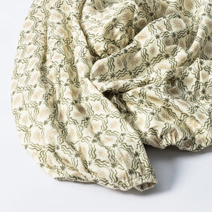 Babyletto fitted crib sheet with green wavy lines and tan star pattern