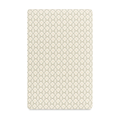 Babyletto crib sheet with a beige and olive green geometric lattice pattern