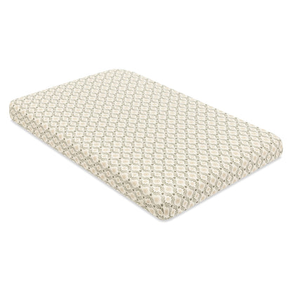 Babyletto crib mattress with cream and green geometric wave pattern sheet