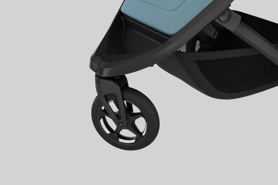 Close-up of black stroller front wheel with five-spoke design, light blue seat, and black frame against neutral background.