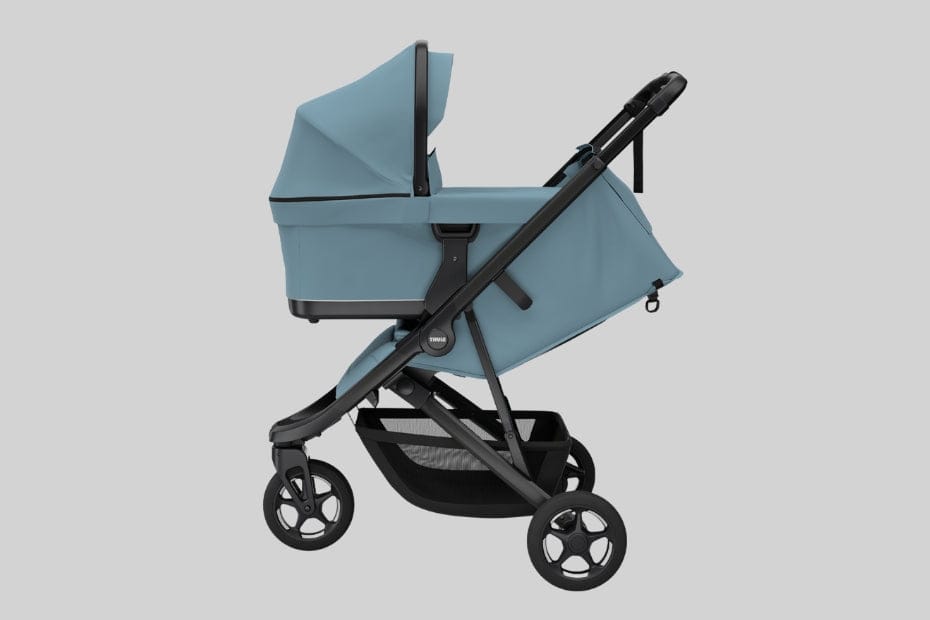 Light blue baby stroller with black frame and wheels, featuring a canopy and storage basket, shown in profile against a neutral background.