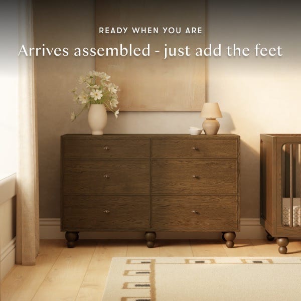 Babyletto six drawer dresser with wood grain finish and round feet