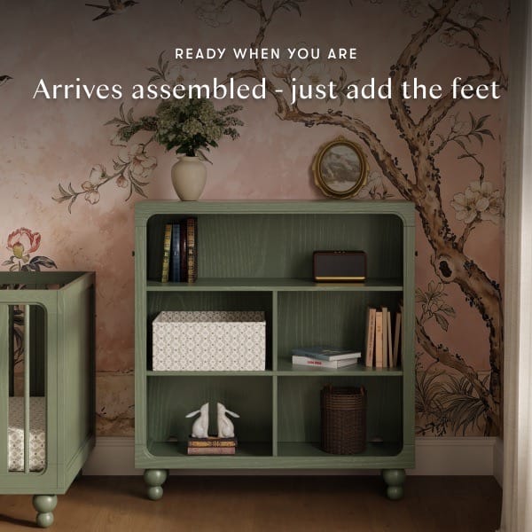 Babyletto green wooden bookshelf with open shelving and rounded corners