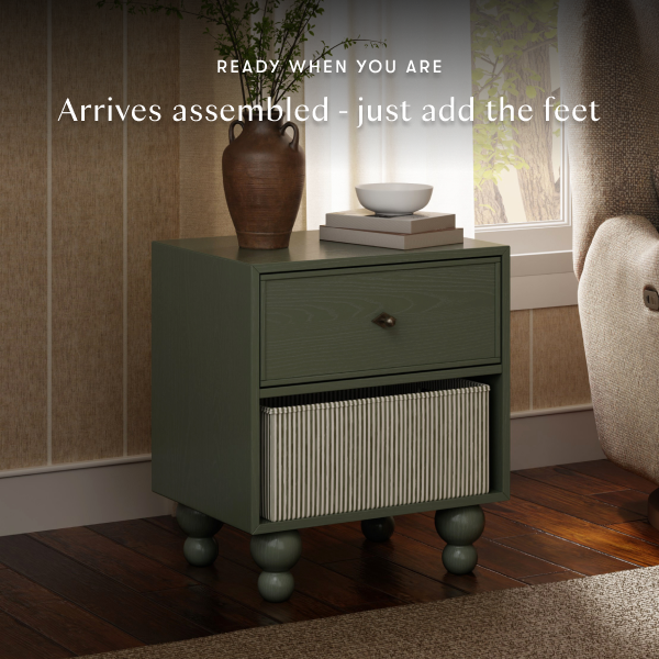 Babyletto olive green nightstand with one drawer and a lower storage basket on wooden floors