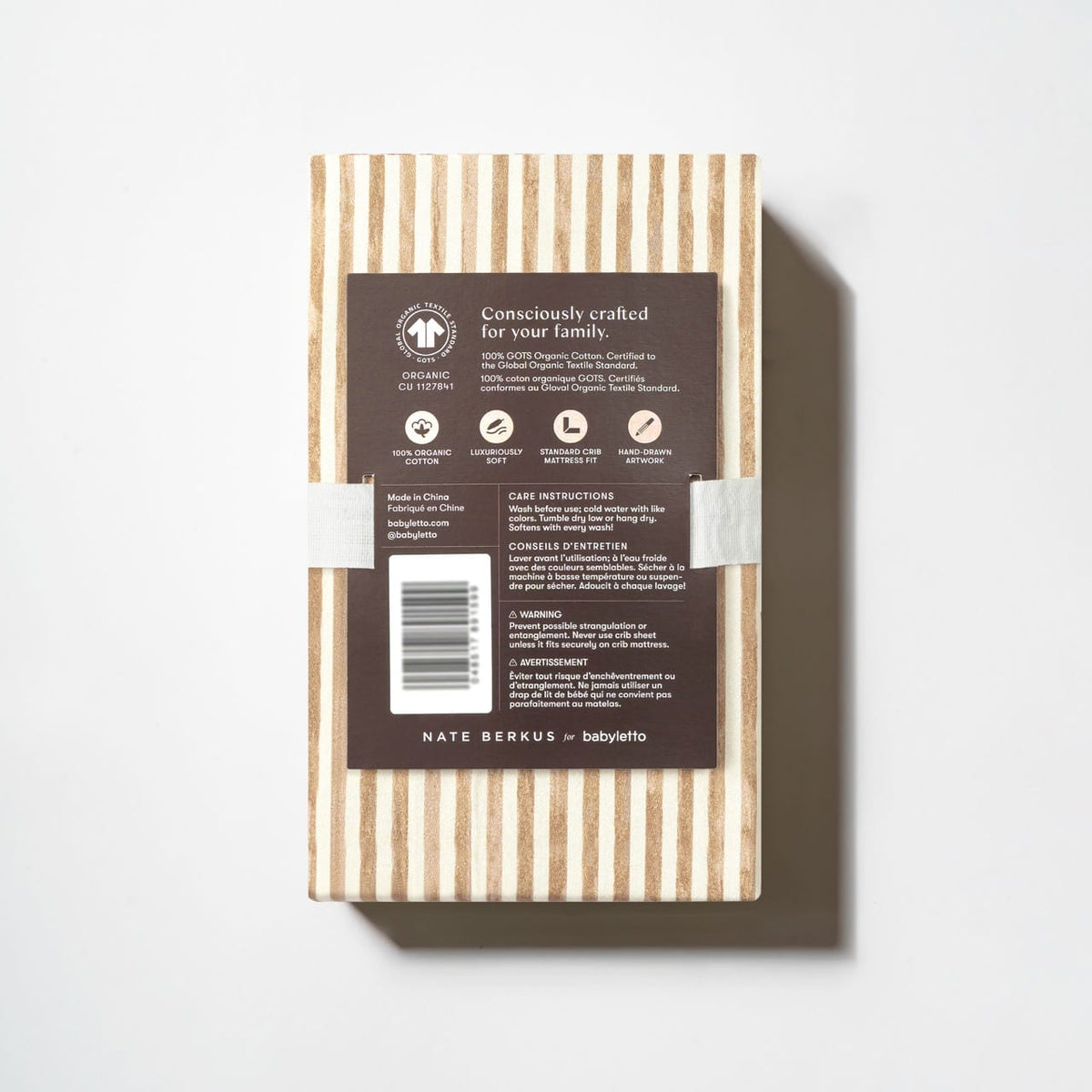 Babyletto crib sheet packaging with product information and care instructions