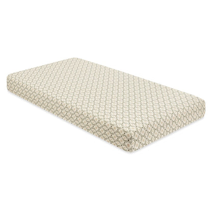 Babyletto crib mattress with a cream and olive green geometric pattern