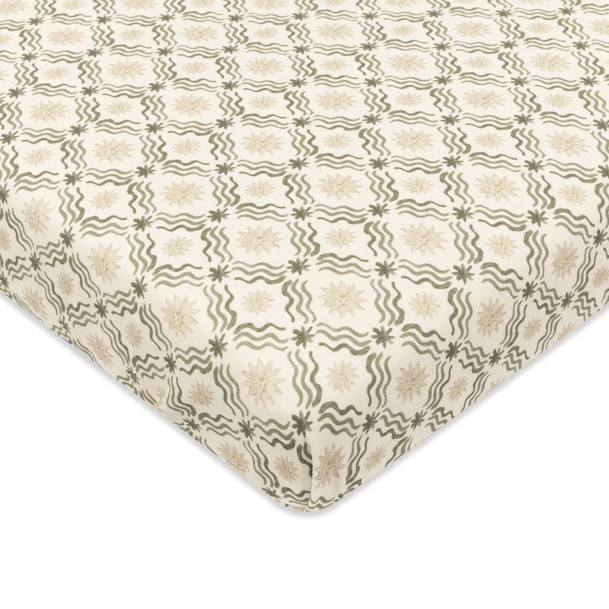 Babyletto crib sheet with cream background and repeating olive green wavy line and star pattern
