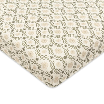 Babyletto crib sheet with cream background and repeating olive green wavy line and star pattern