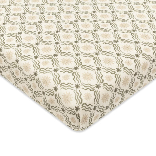 Babyletto crib sheet with cream background and repeating olive green wavy line and star pattern