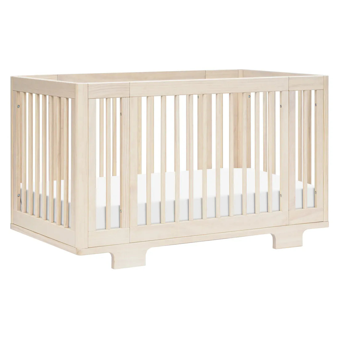 Babyletto natural wood crib with slatted sides and white mattress