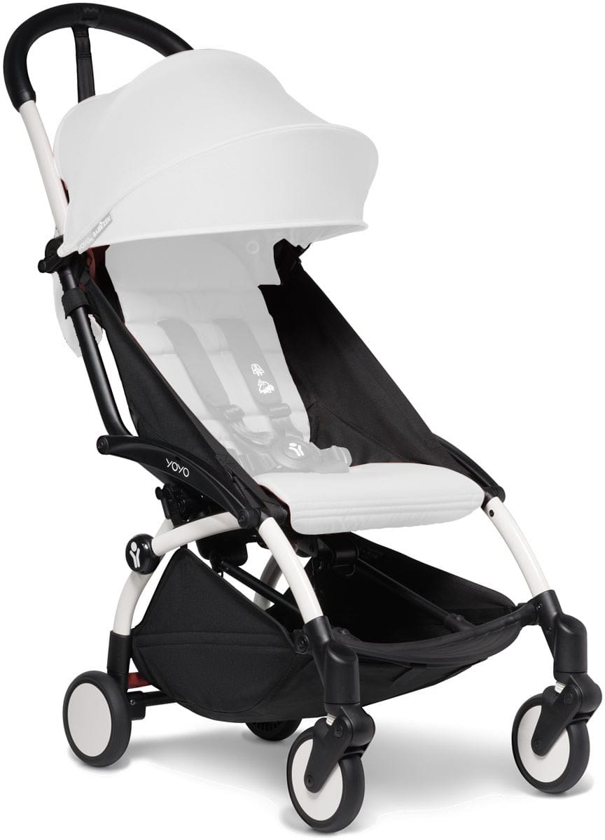 White Babyzen YOYO2 ultra compact stroller frame with black accents, white canopy, and four wheels, front three-quarter view