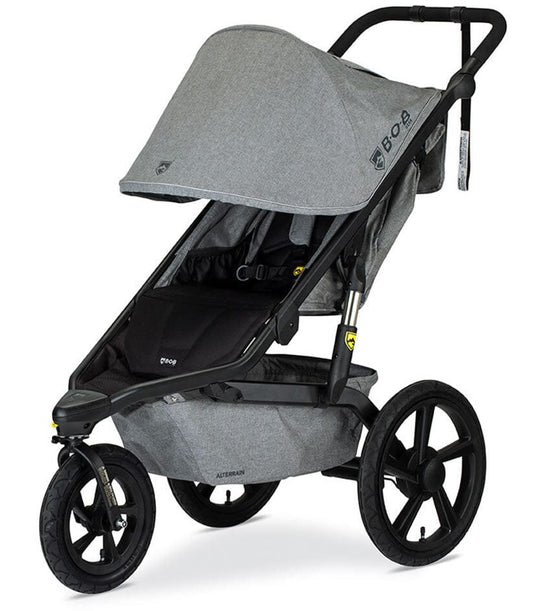 Melange gray jogging stroller by BOB with black frame, large all-terrain wheels, and adjustable canopy, side view
