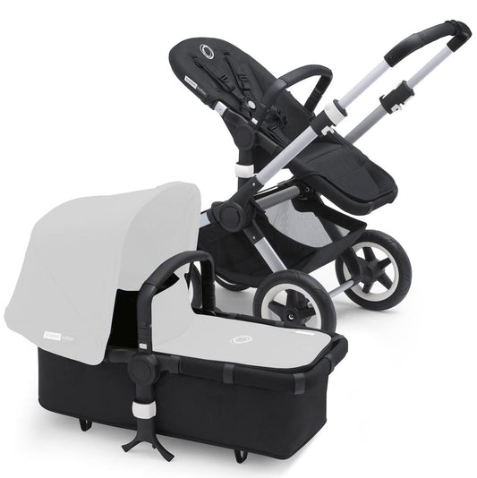 Aluminum and black Bugaboo Buffalo stroller base with matching carrycot, side view showing sleek frame and white canopy.