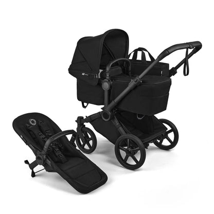 Black single-to-double stroller by Bugaboo with matching carrycot and seat unit, sleek matte finish, large spoked wheels, side view display