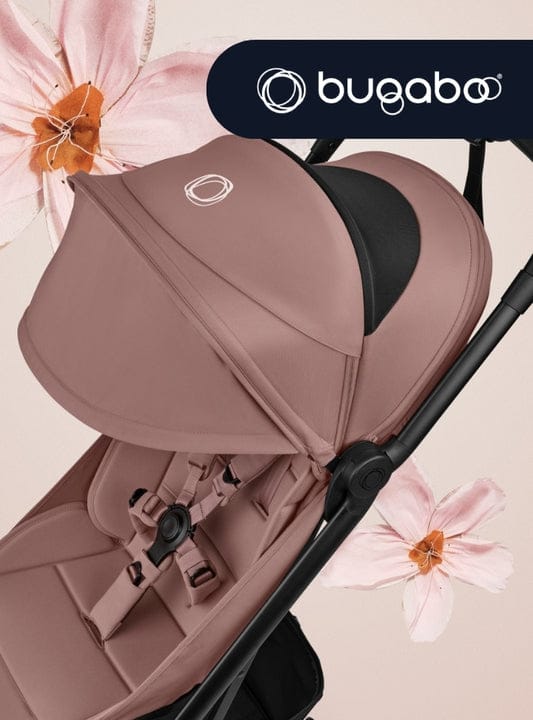 Rose-colored Bugaboo stroller with black frame, floral accents, and brand logo, soft lighting.