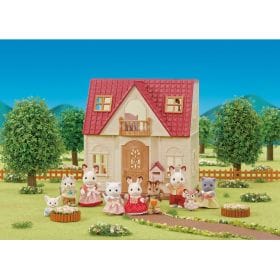 Sylvanian Families Red Roof Country Home with animal figures in a garden setting