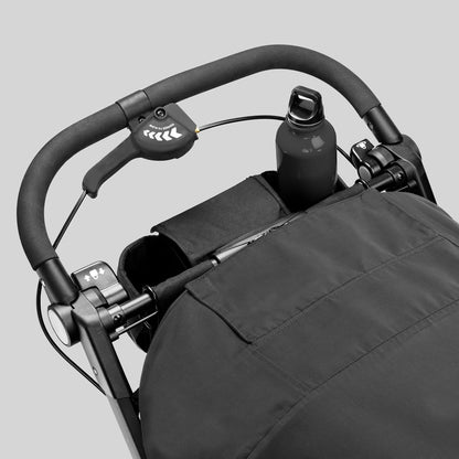 Black stroller handlebar with integrated hand brake and bottle holder