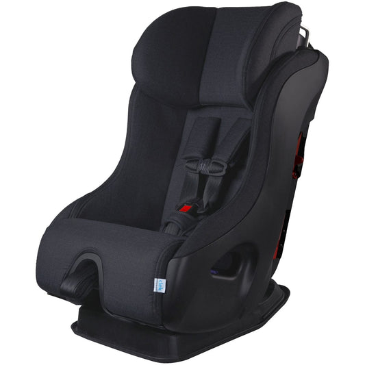 Black narrow convertible car seat by Clek, Mammoth Ziip model, with textured fabric, red buckle accents, and anti-rebound bar, side view.