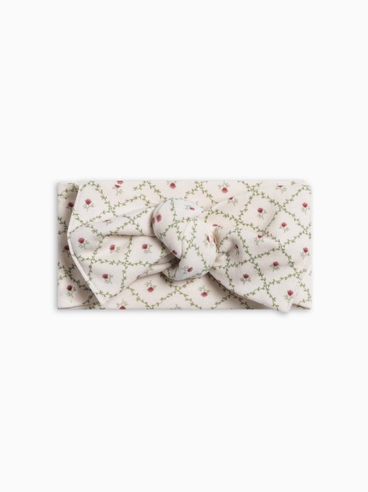 Colored Organics knotted baby headband in cream with green vine and red floral lattice print