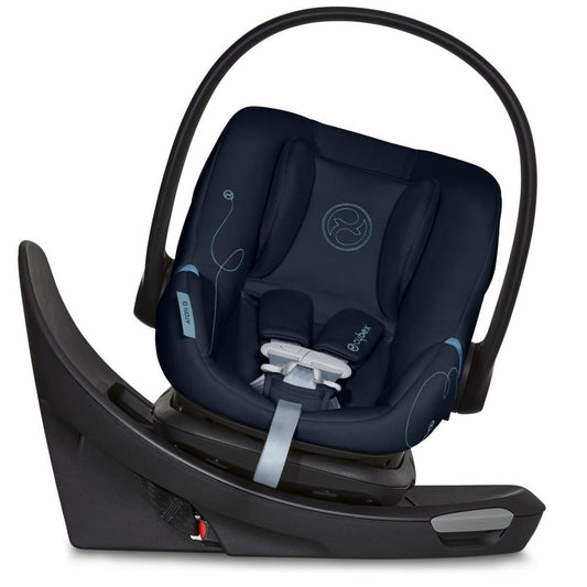 Ocean blue rotating infant car seat by Cybex with swivel base, padded navy upholstery, light blue stitching, and black frame in side view