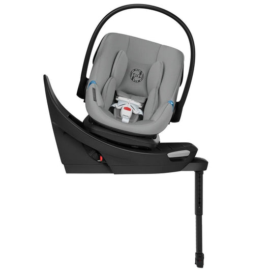 Stone grey infant car seat with black base and load leg by Cybex, featuring swivel design and padded headrest, side view