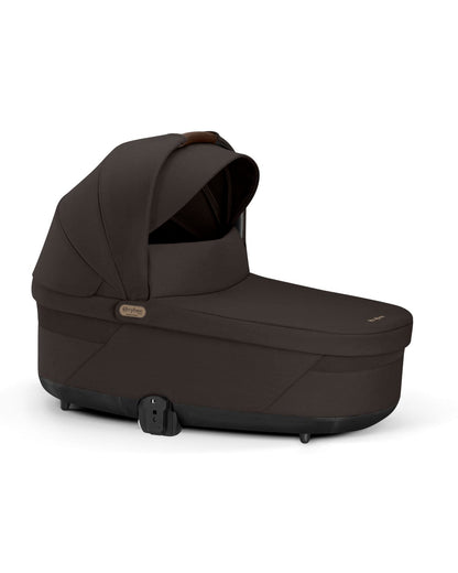 Dark brown Cybex carrycot with canopy and leather handle detail