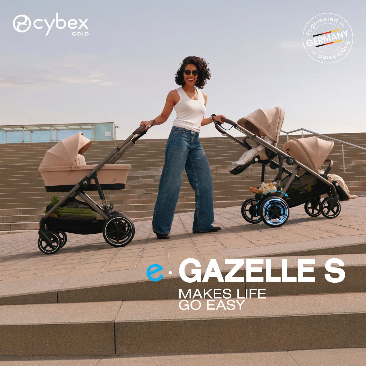 Woman walking with two Cybex e-Gazelle S strollers on outdoor stairs