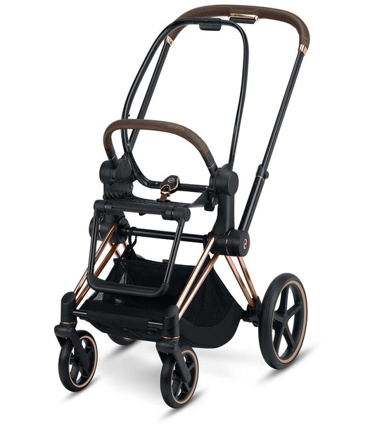 Rose gold and black electronic assist stroller frame by Cybex, featuring brown leatherette handles, mesh storage basket, and five-spoke wheels, front three-quarter view