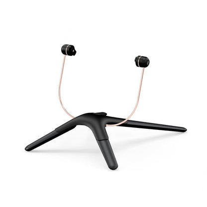 Black and rose gold wireless earbuds on a black tripod stand