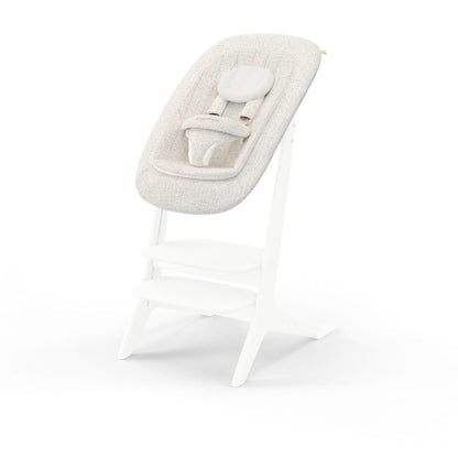 Stokke Steps bouncer with beige fabric seat on white wooden frame