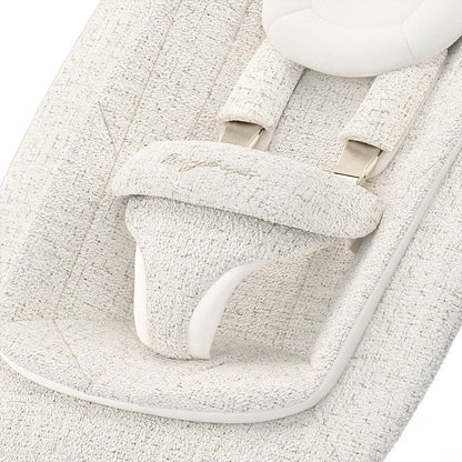 Cybex baby bouncer seat with textured cream fabric and safety harness