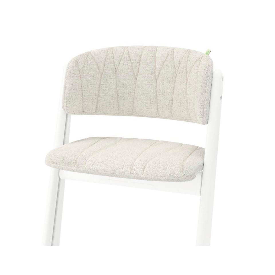 White wooden chair with beige upholstered seat and backrest featuring stitched leaf pattern