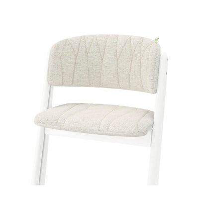 White wooden chair with beige upholstered seat and backrest featuring stitched leaf pattern