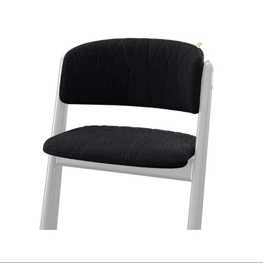Black upholstered chair with white frame and textured seat and backrest
