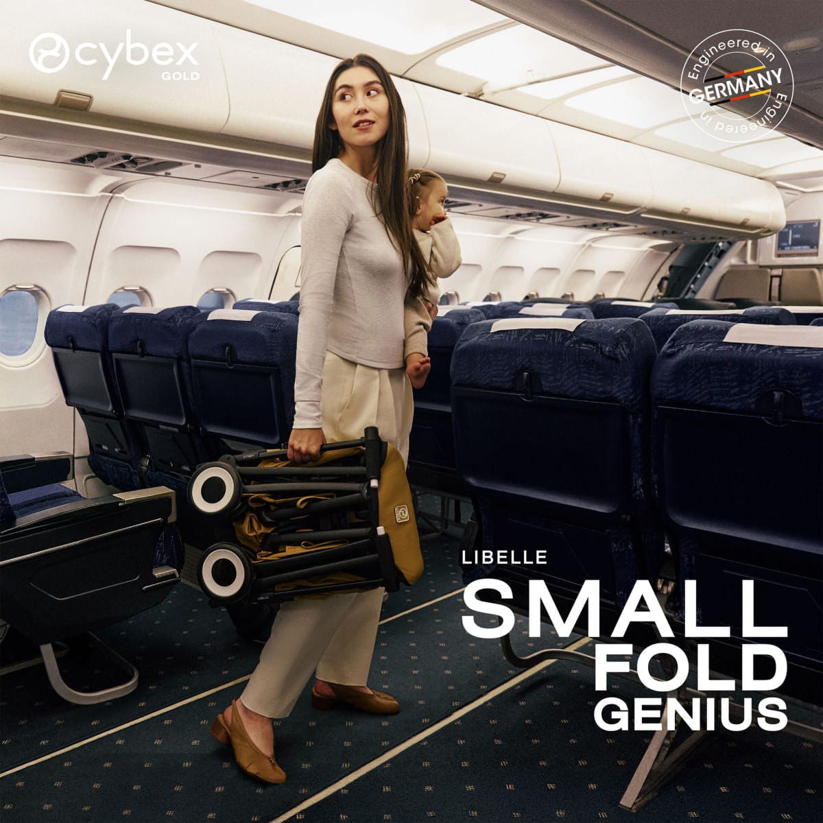 Woman holding a folded Cybex Libelle stroller while carrying a child in an airplane aisle